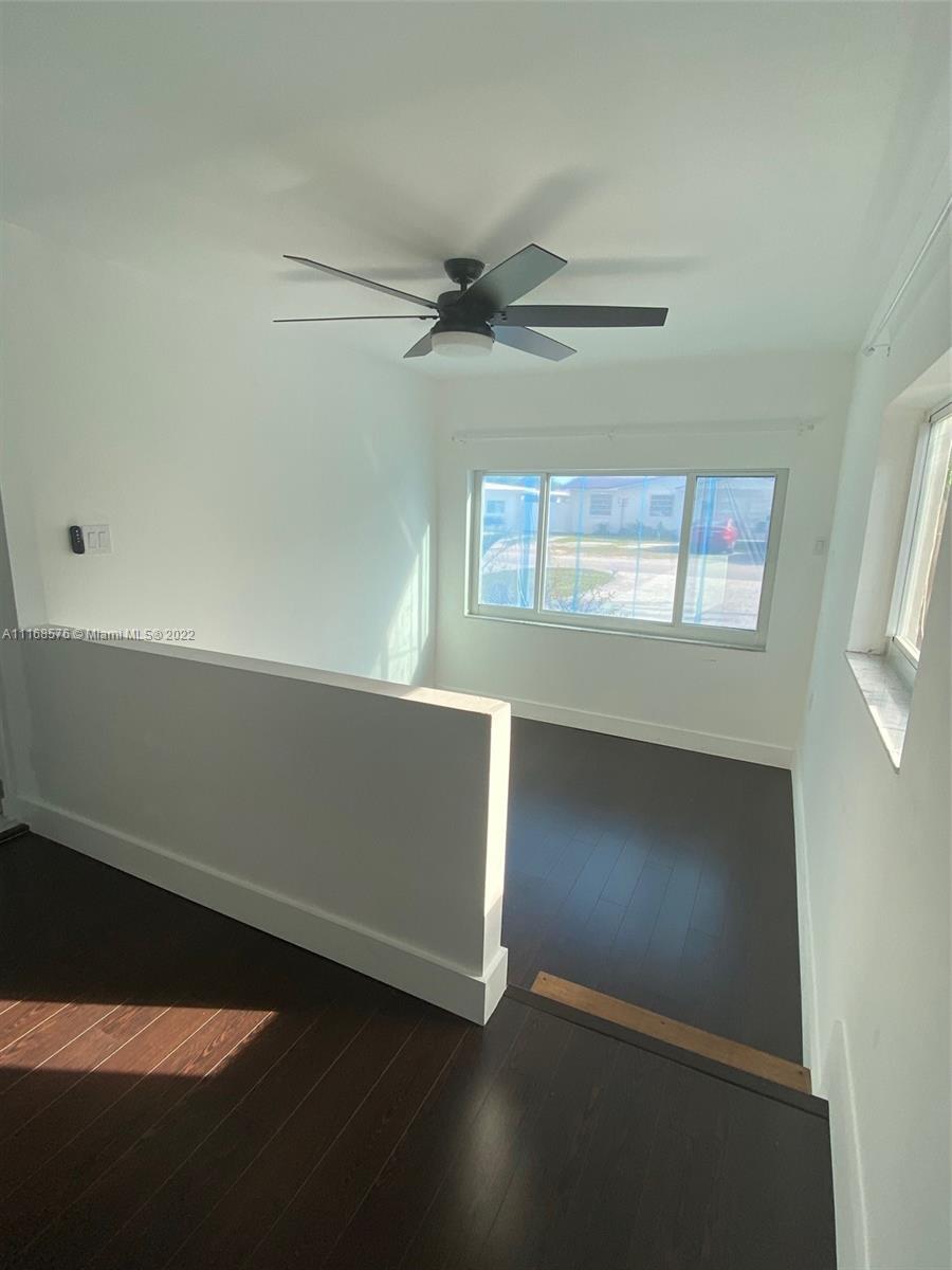 6561 Southwest 30th Street, Unit FRONT Miami, FL 33155 - Photo 5 of 18 an empty room with windows