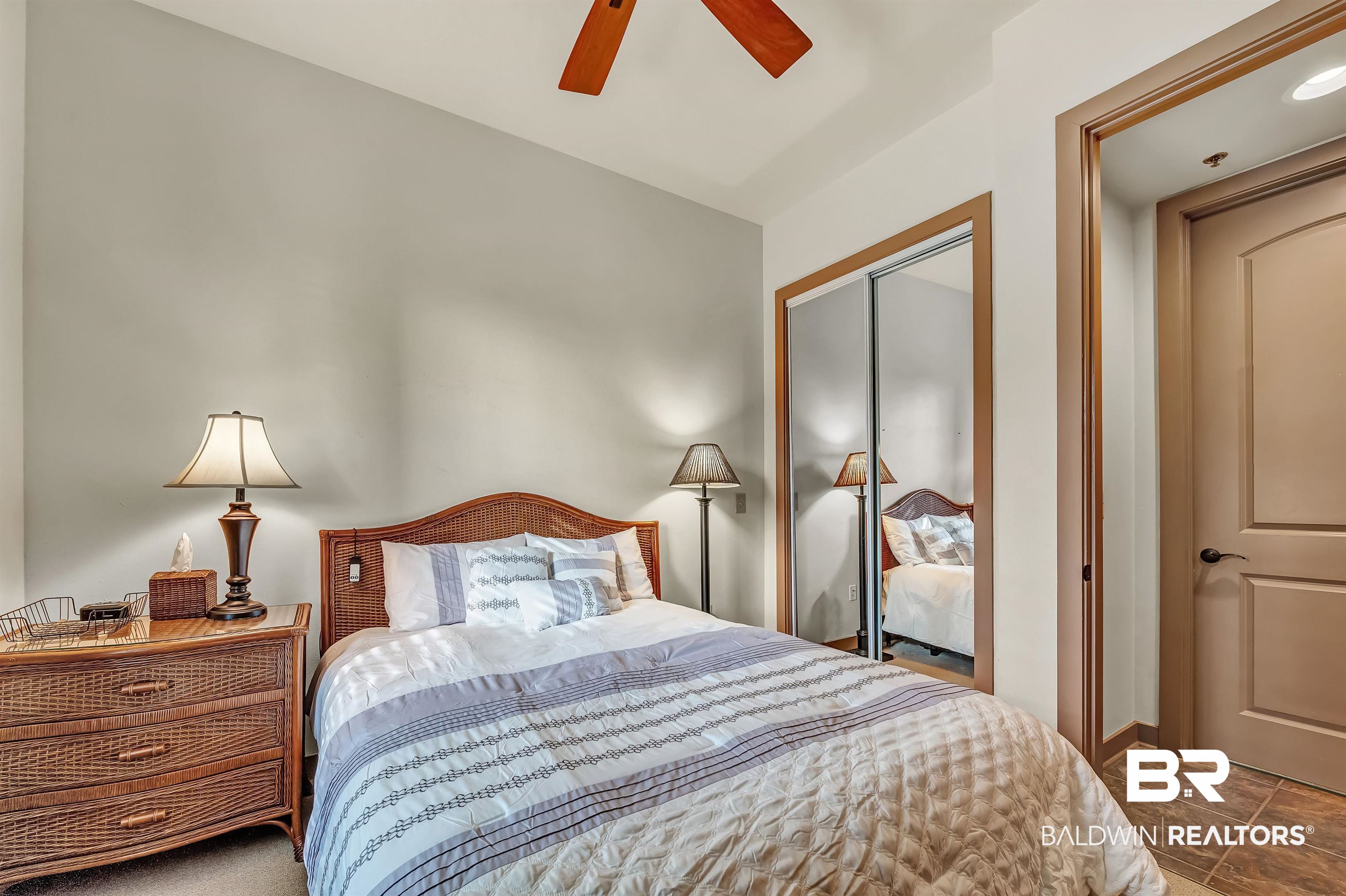 1430 Regency Road, Unit C201 Gulf Shores, AL 36542 - Photo 45 of 54 Bedroom featuring a closet and ceiling fan