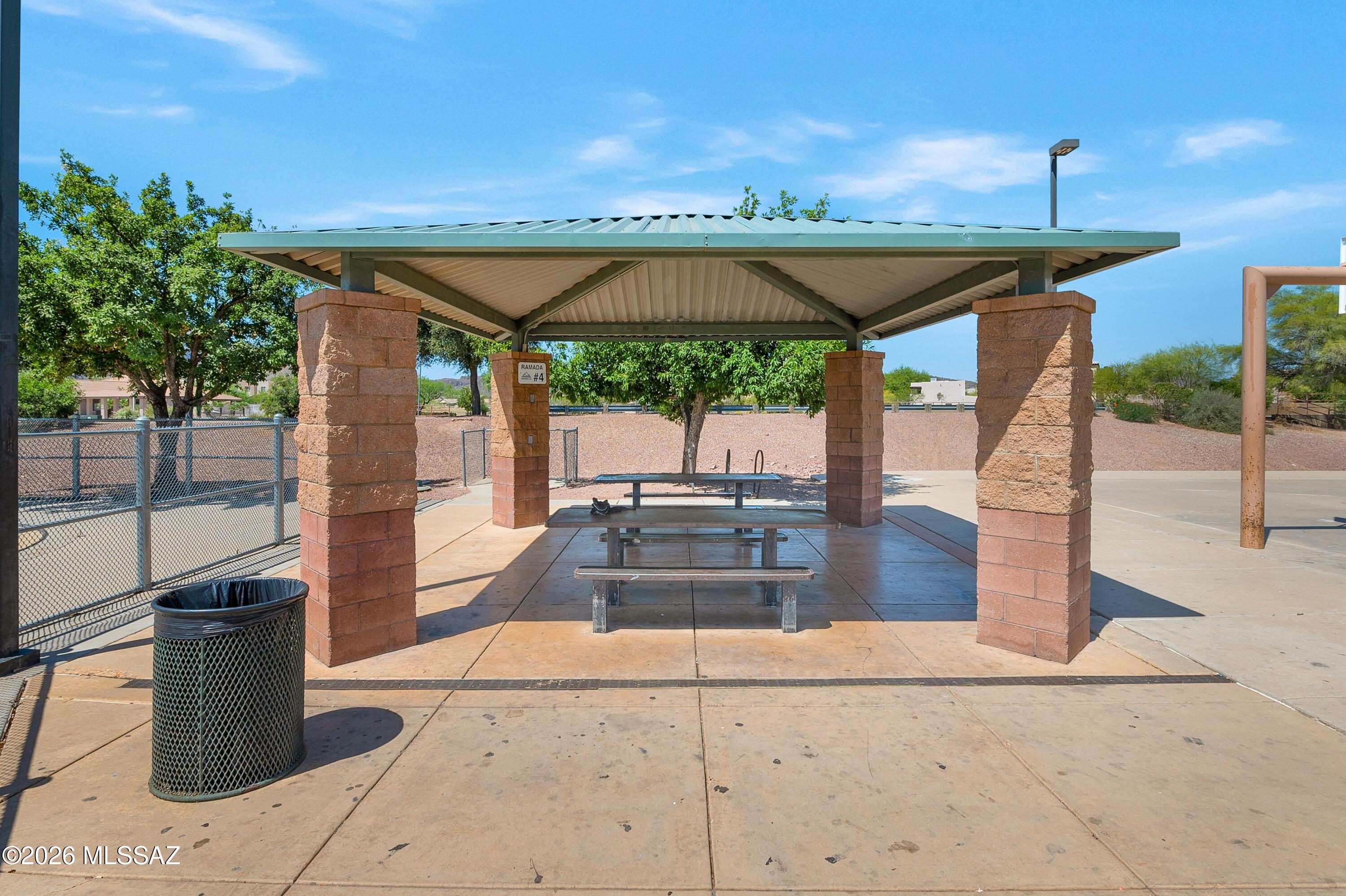 7159 West Maple Ridge Drive Tucson, AZ 85743 - Photo 39 of 42 a backyard of a house with table and chairs