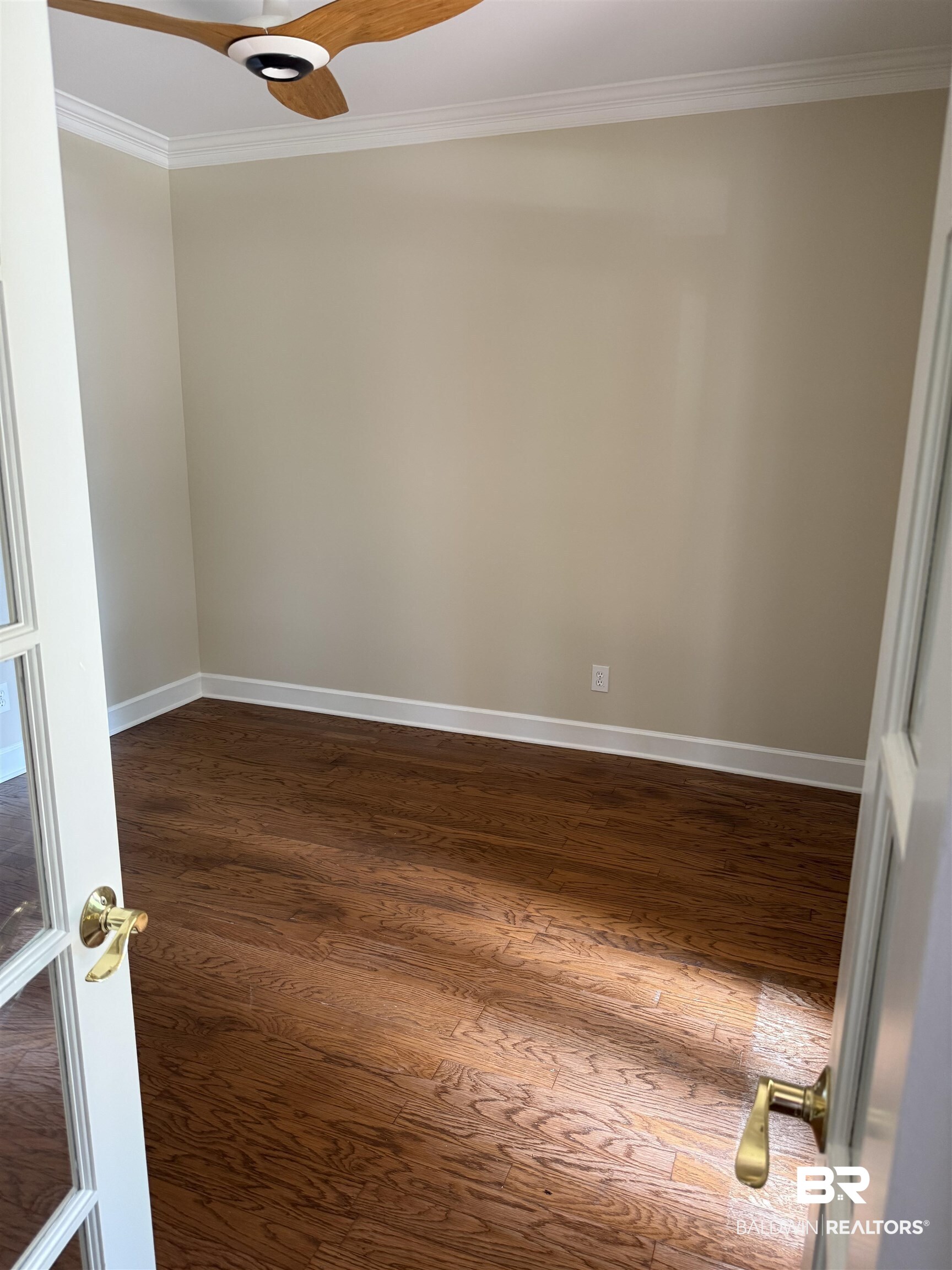 508 Barbara Court Daphne, AL 36526 - Photo 10 of 16 Spare room featuring crown molding, dark wood-style flooring, and a ceiling fan