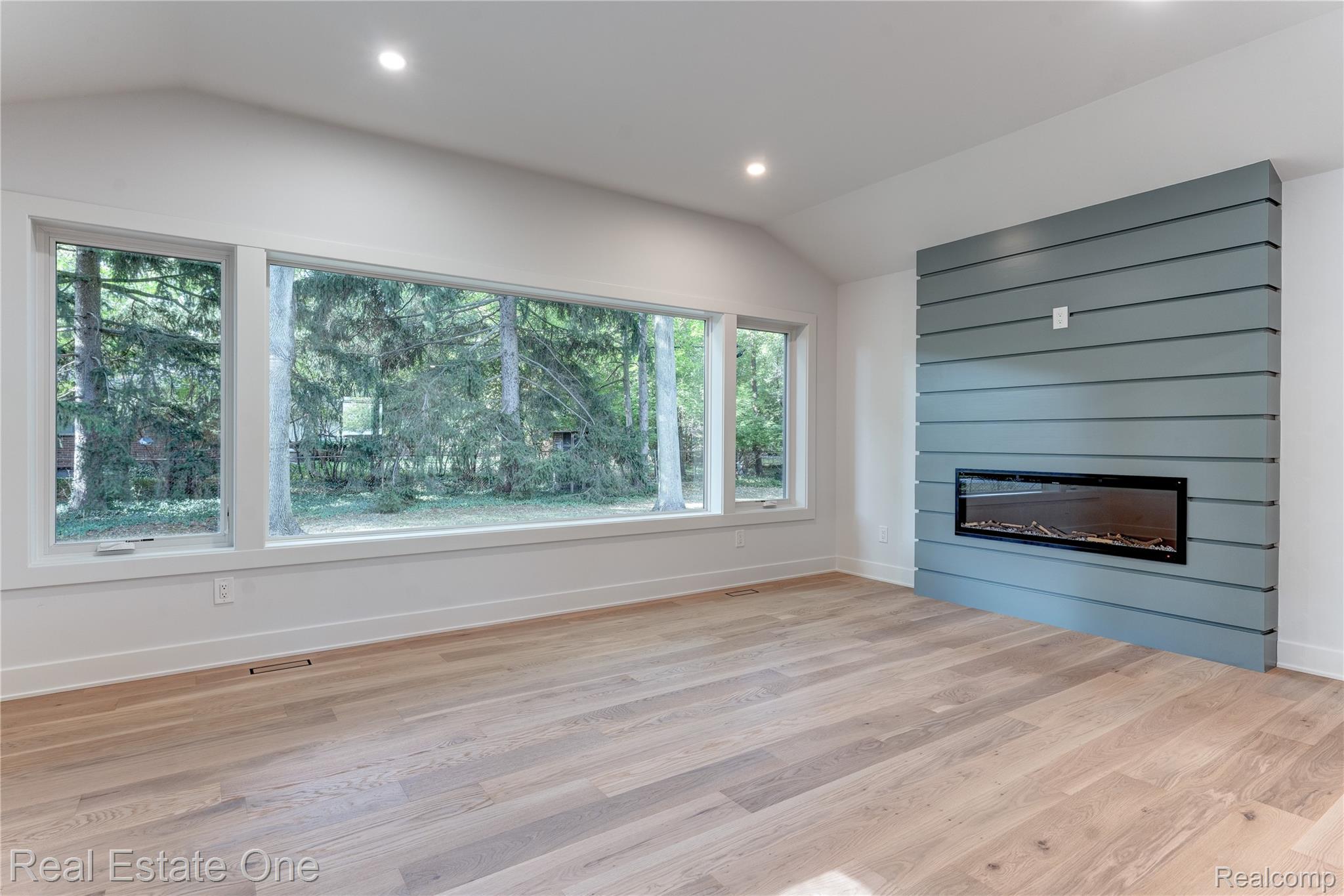 786 South Cranbrook Road Bloomfield Hills, MI 48301 - Photo 10 of 38 Unfurnished living room with vaulted ceiling, wood finished floors, recessed lighting, and a fireplace