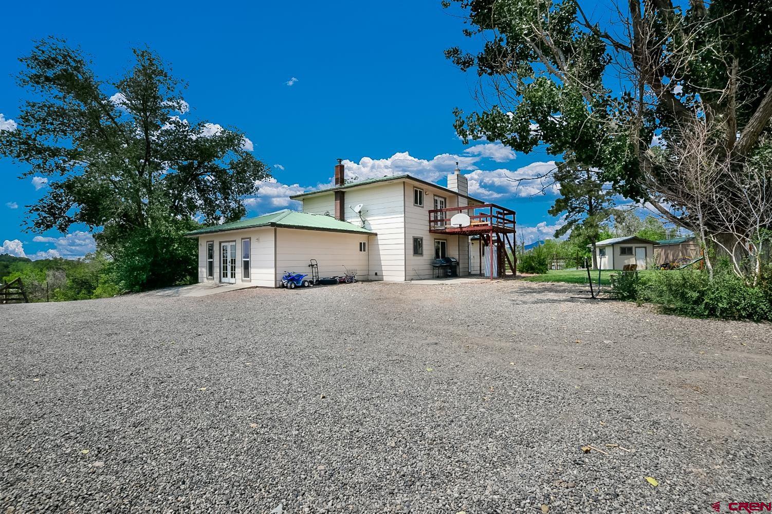 22247 H75 Road Delta, CO 81416 - Photo 2 of 35 a front view of a house with a yard and garage