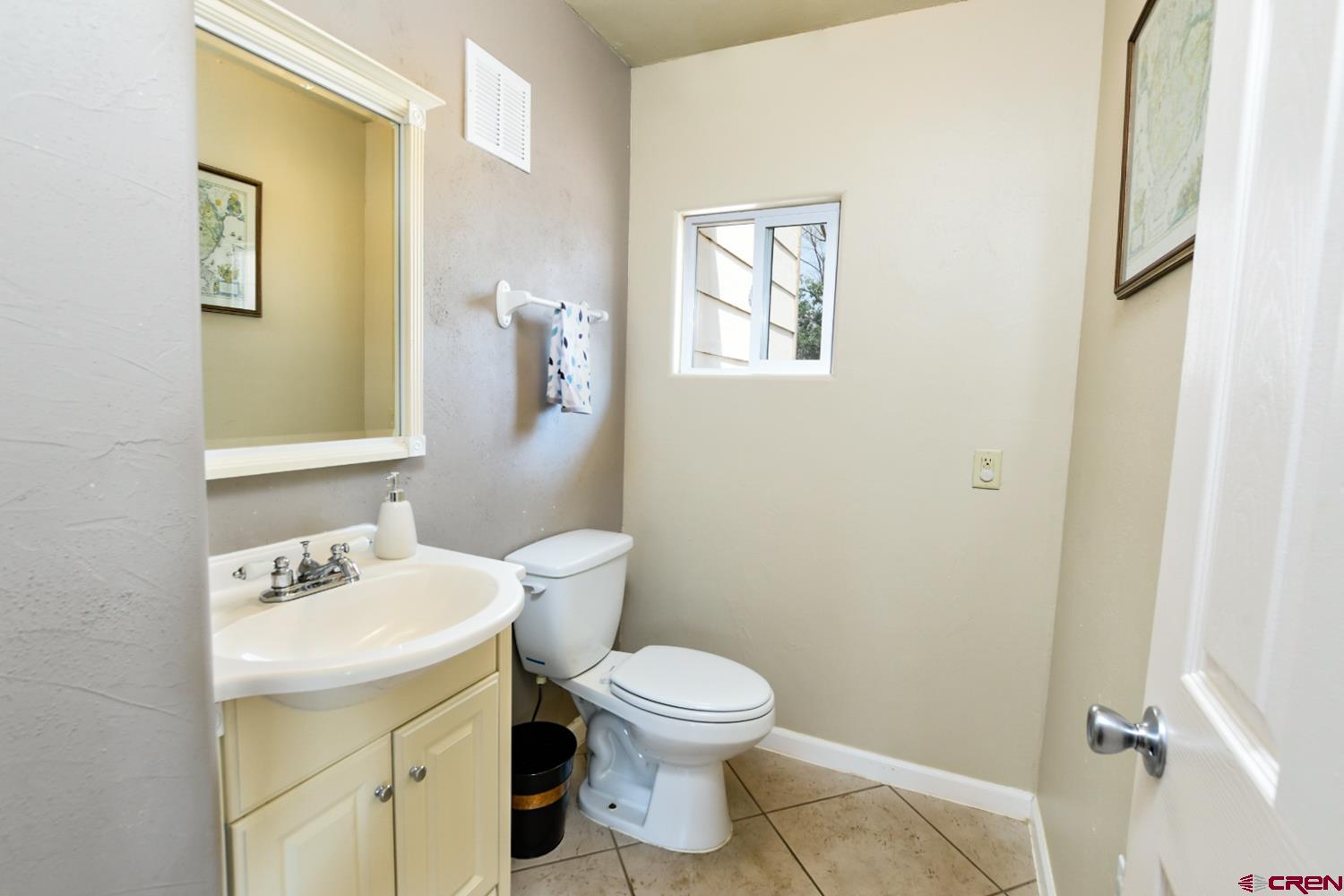 22247 H75 Road Delta, CO 81416 - Photo 12 of 35 a bathroom with a toilet a sink and mirror