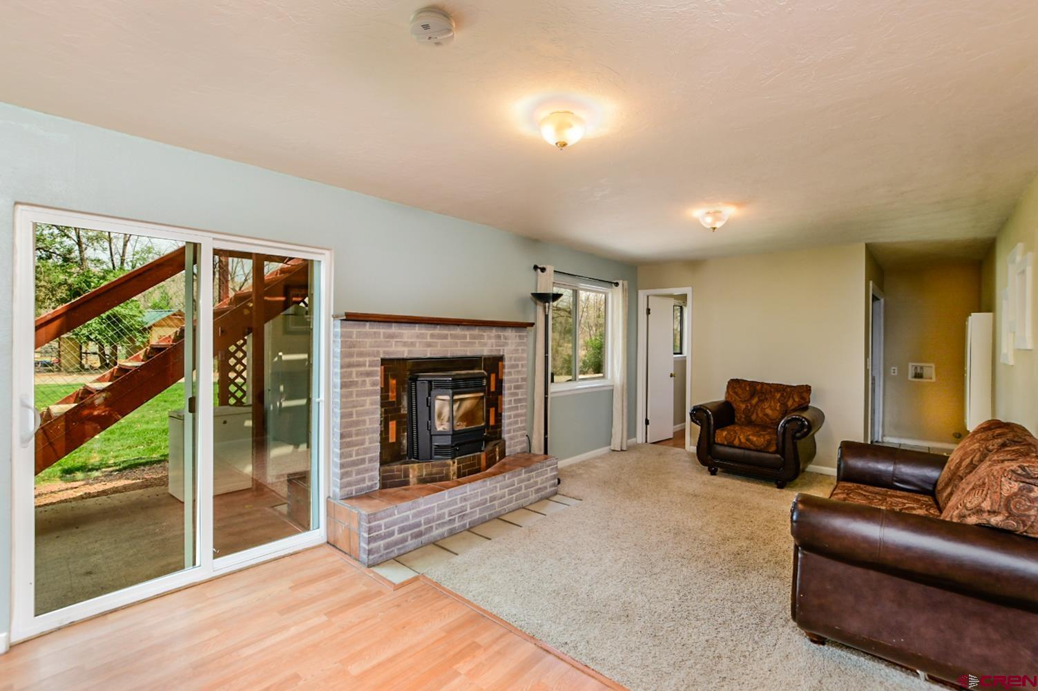 22247 H75 Road Delta, CO 81416 - Photo 16 of 35 a living room with furniture and a fireplace