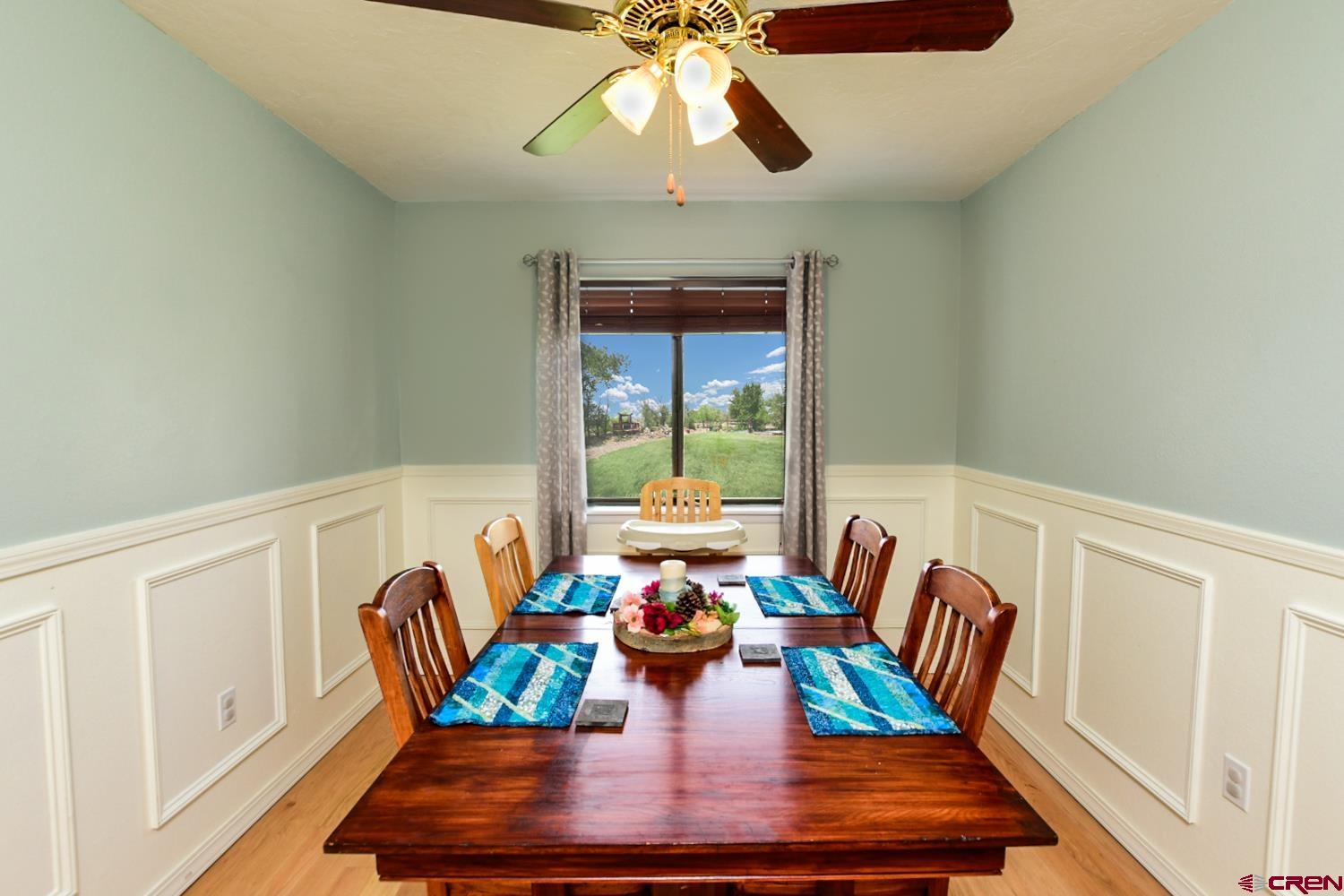 22247 H75 Road Delta, CO 81416 - Photo 17 of 35 a view of a dining room with furniture a chandelier and wooden floor