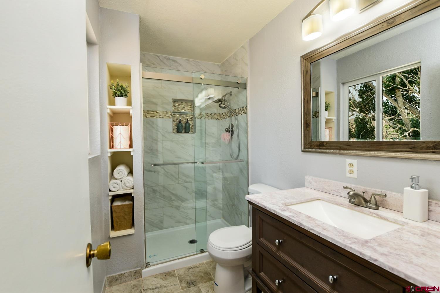 22247 H75 Road Delta, CO 81416 - Photo 27 of 35 a bathroom with a granite countertop sink toilet and shower