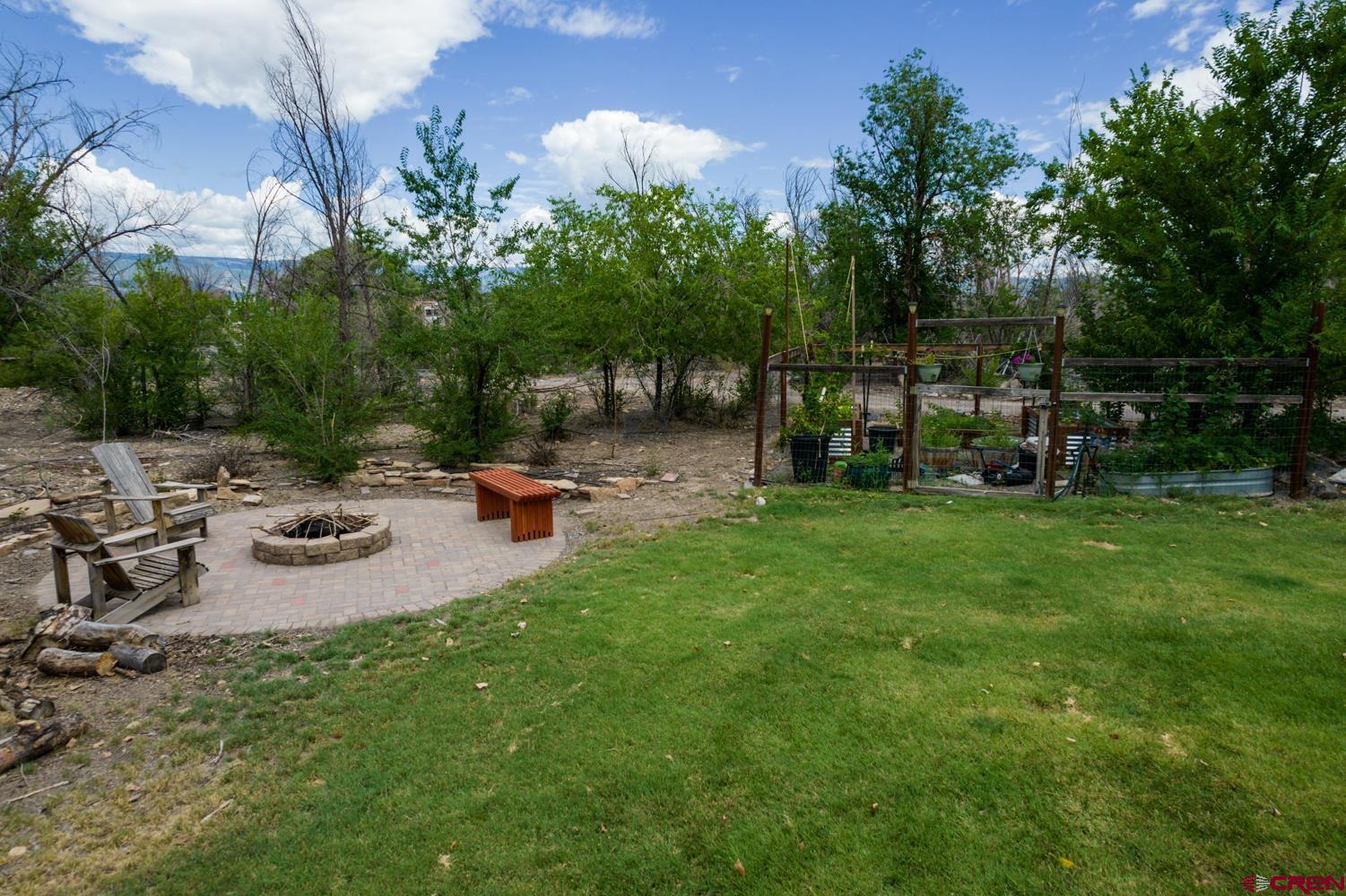 22247 H75 Road Delta, CO 81416 - Photo 32 of 35 a backyard of a house with table and chairs