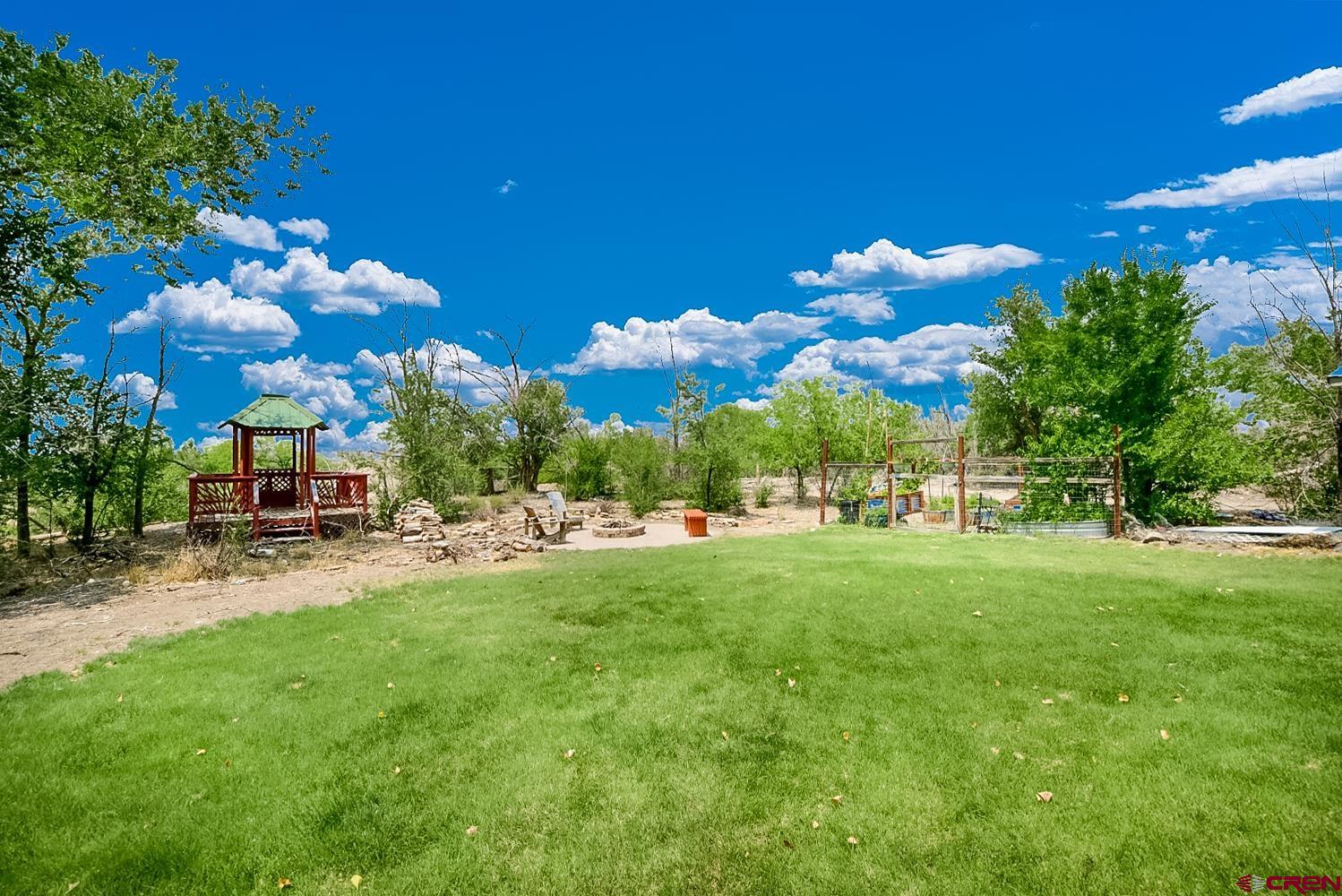 22247 H75 Road Delta, CO 81416 - Photo 7 of 35 a view of a house with a backyard porch and sitting area