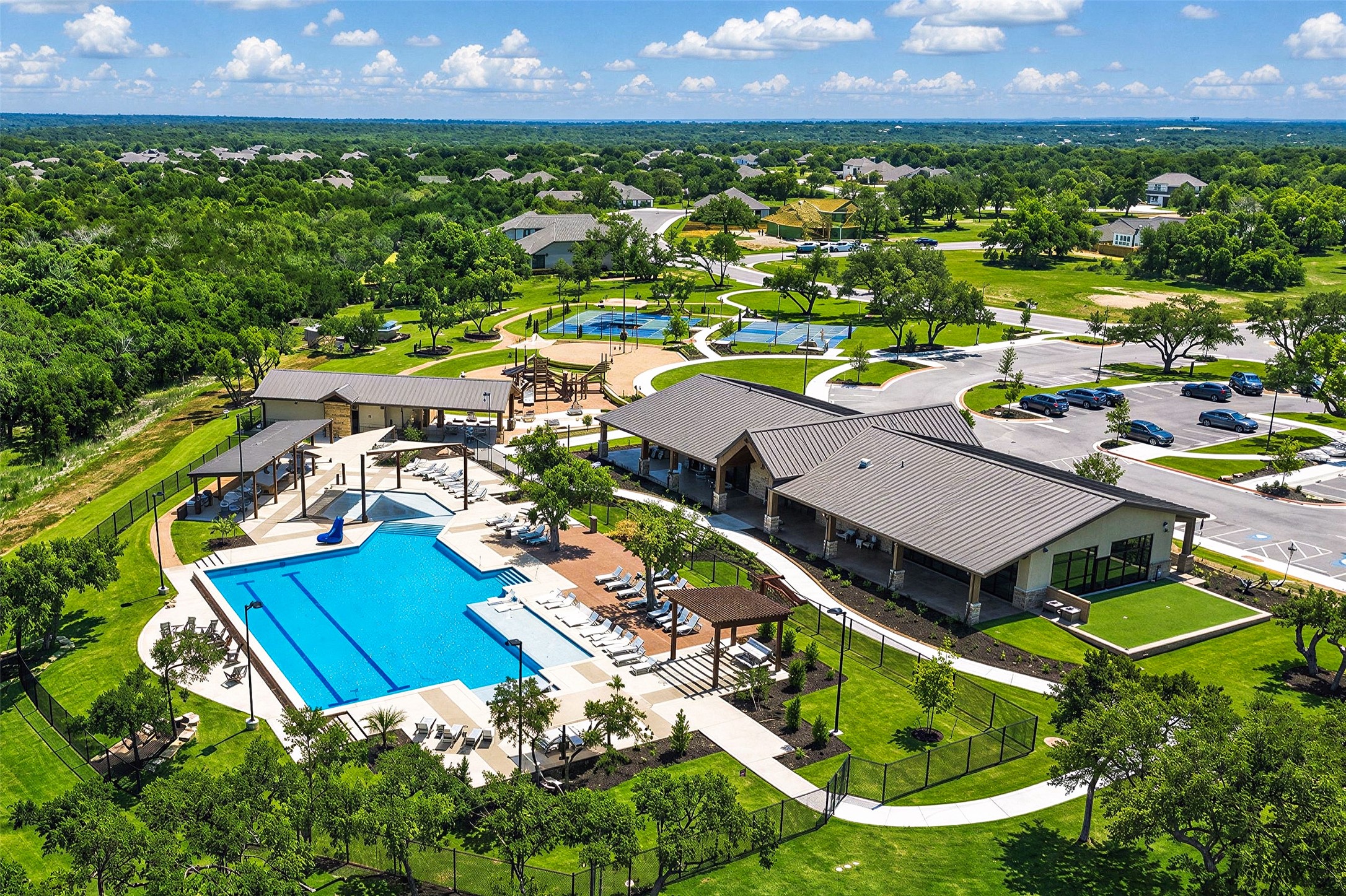 2408 Nate's Place Georgetown, TX 78633 - Photo 34 of 40 An aerial perspective showcases a vibrant community recreation area, offering diverse amenities for leisure and play.