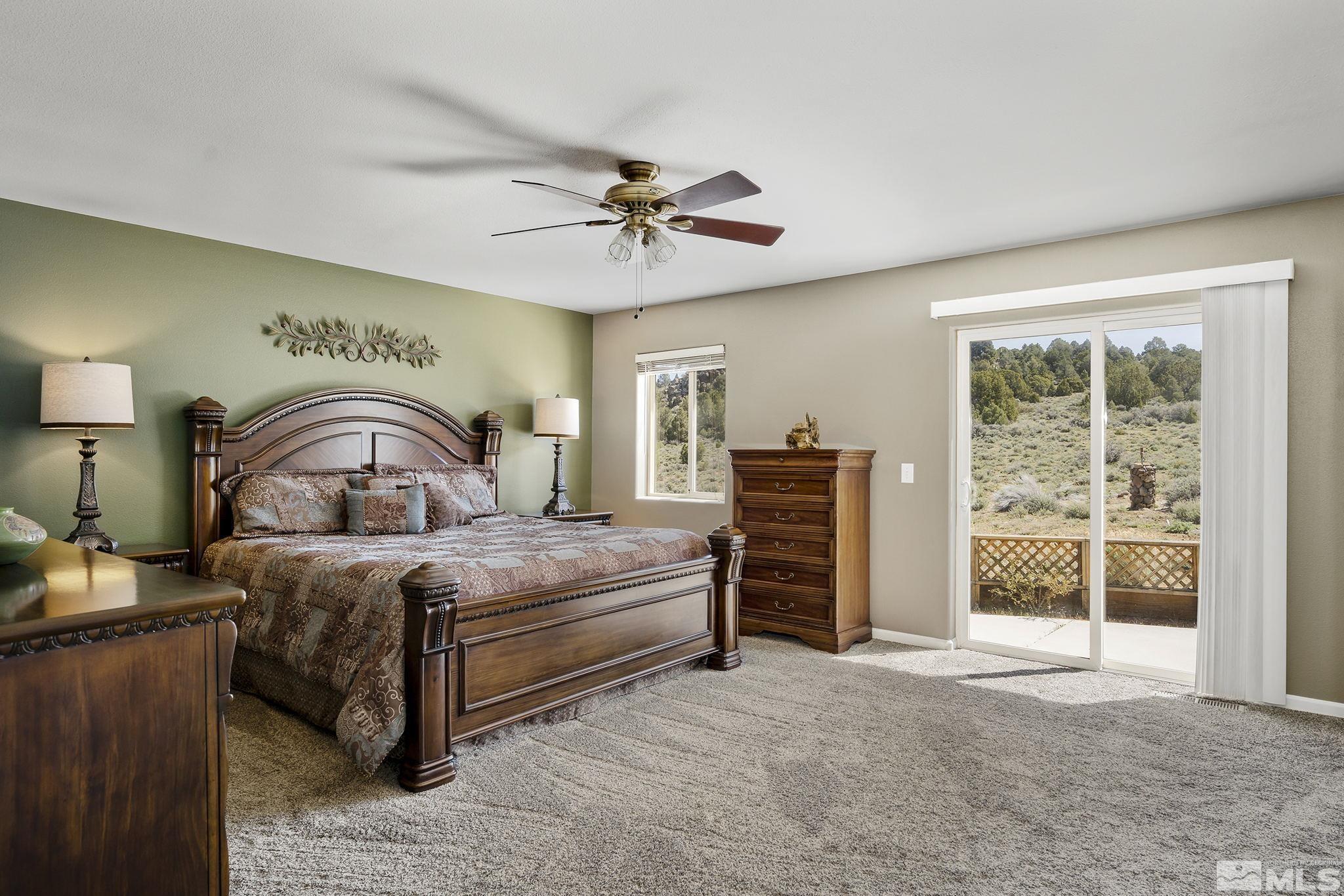 2291 Lousetown Road Reno, NV 89521 - Photo 17 of 40 a bedroom with bed and a chandelier