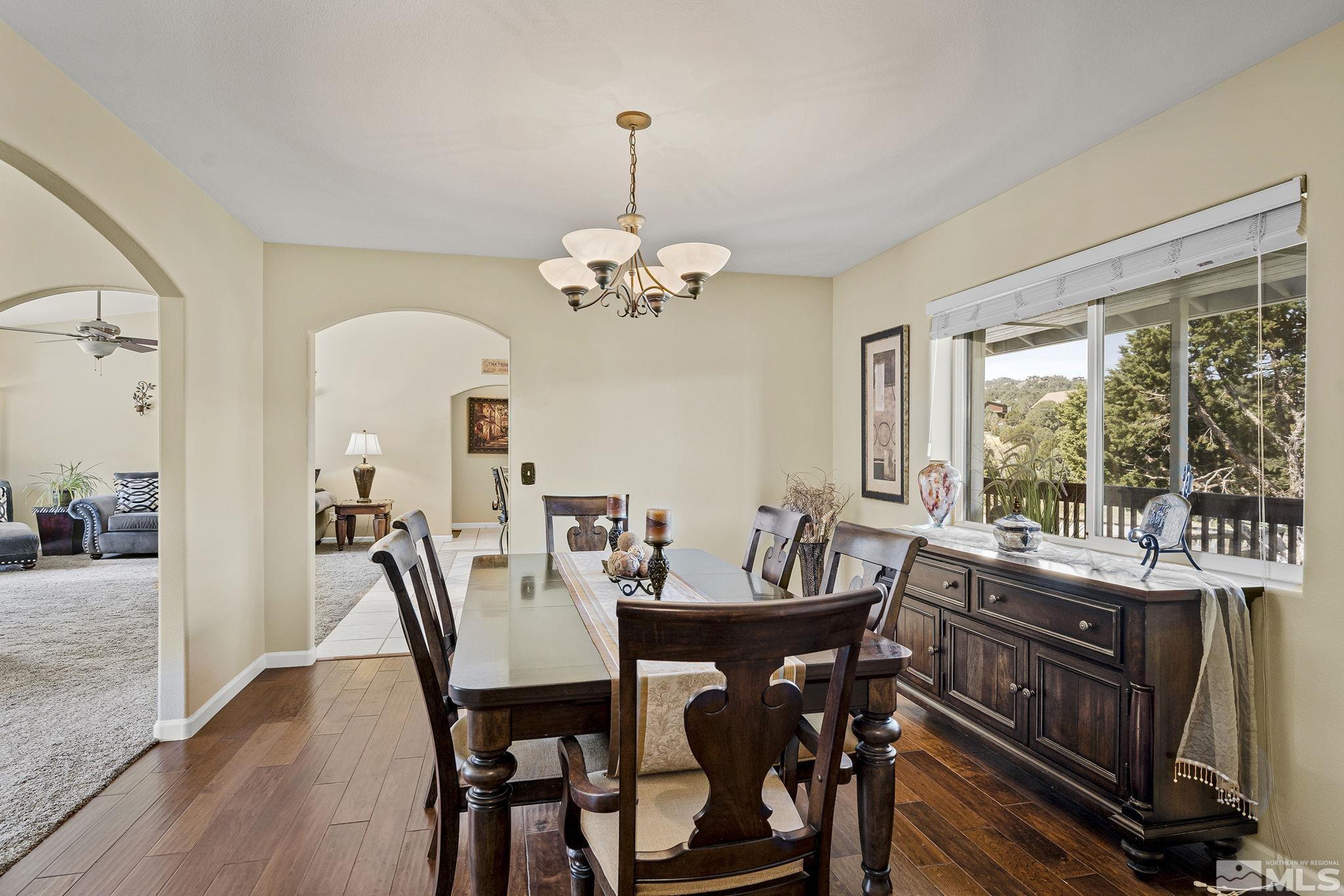 2291 Lousetown Road Reno, NV 89521 - Photo 10 of 40 a view of a dining room with furniture a chandelier and wooden floor