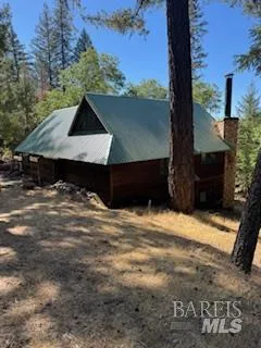 a view of wooden fence and a trees in the background