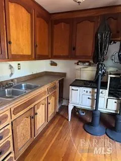 a kitchen with a sink cabinets and appliances