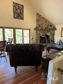 a living room with furniture a fireplace and large windows