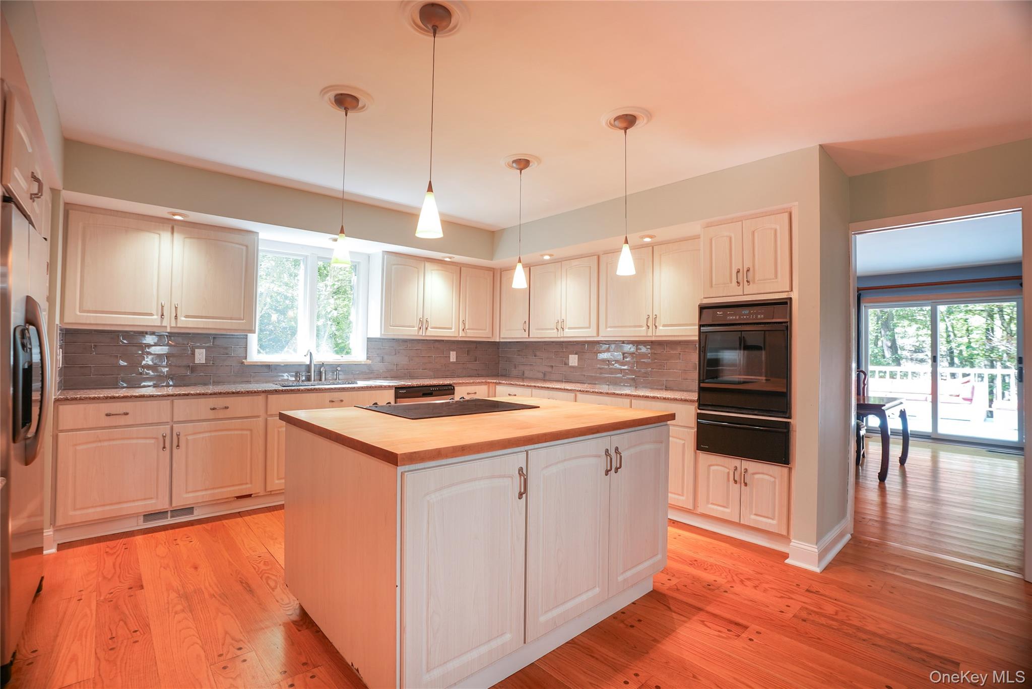 22 Peters Lane Pound Ridge, NY 10576 - Photo 12 of 43 Kitchen featuring light wood cabinetry, butcher block island, stainless steel appliances, and wood-finish flooring