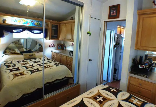 a bedroom with a bed and a mirror