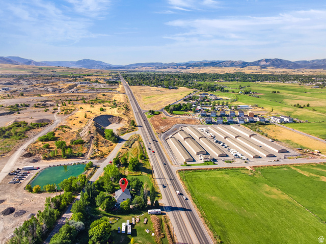 4380 Main Street Logan, UT 84321 - Photo 71 of 74 Property with direct highway frontage, surrounded by expansive green fields, and distant mountain ranges