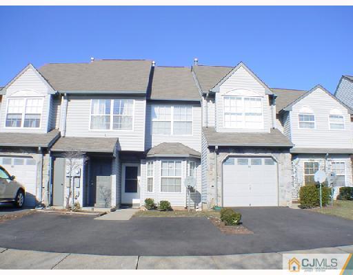 a front view of a residential apartment building with a yard