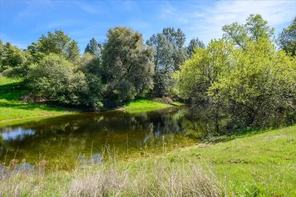 a view of a lake with a house in the background