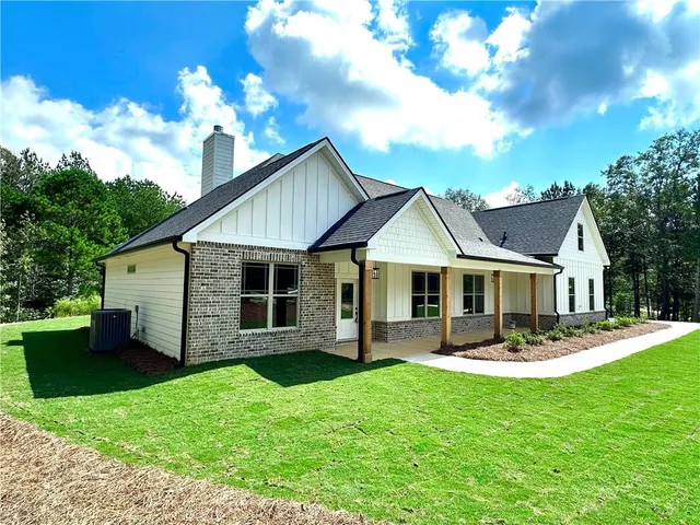 a front view of a house with garden and patio