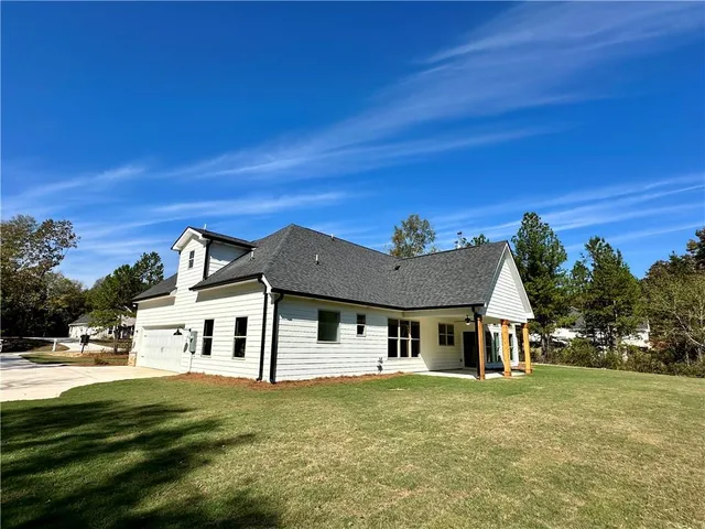 a view of house with outdoor space and garden