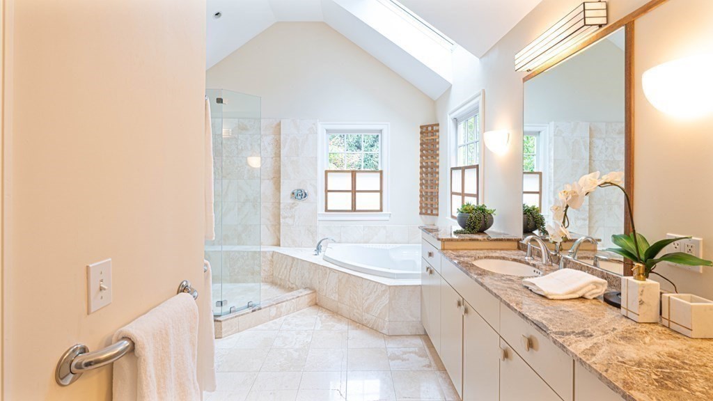 84 Wildwood Drive Needham, MA 02492 - Photo 18 of 36 a spacious bathroom with a granite countertop tub a sink and a large mirror