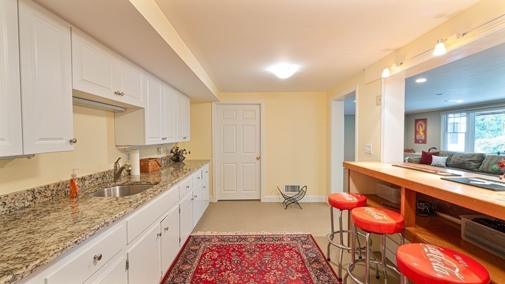 84 Wildwood Drive Needham, MA 02492 - Photo 20 of 36 a large white kitchen with a breakfast area