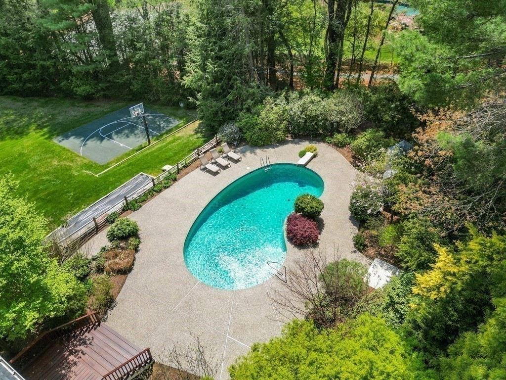 84 Wildwood Drive Needham, MA 02492 - Photo 27 of 36 a view of a swimming pool with a yard