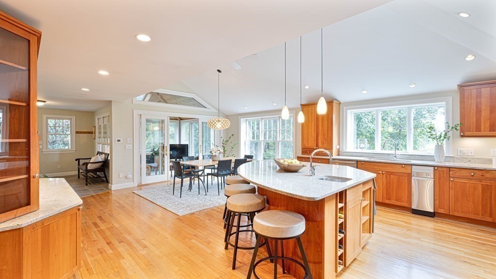 84 Wildwood Drive Needham, MA 02492 - Photo 3 of 36 a dining hall with stainless steel appliances granite countertop furniture a stove a sink a chimney a dining table and chairs