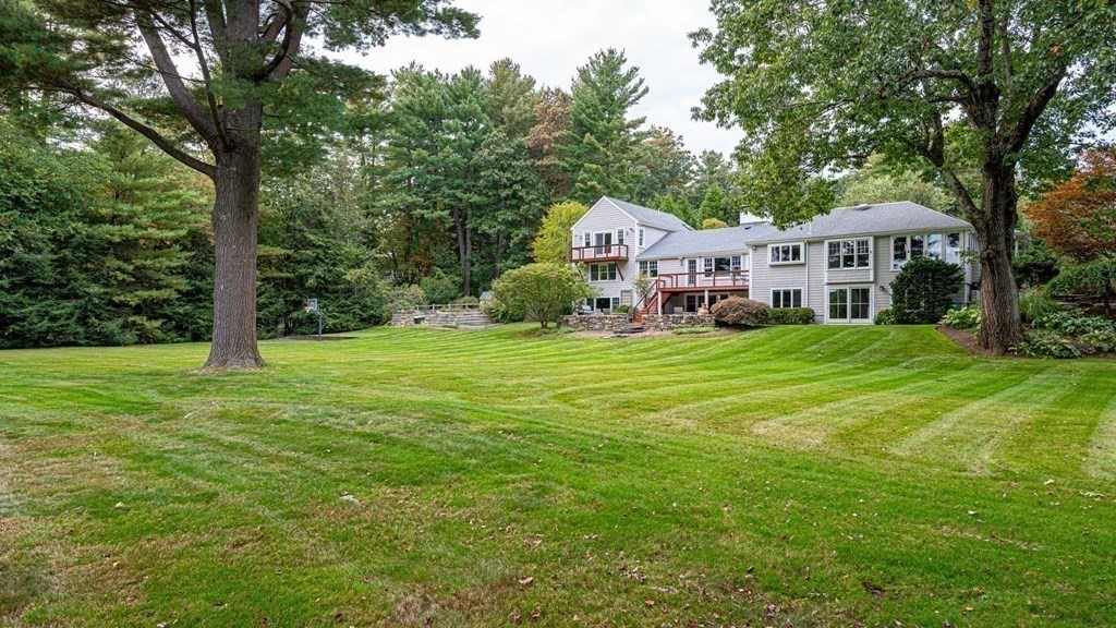 84 Wildwood Drive Needham, MA 02492 - Photo 32 of 36 a front view of a house with a yard