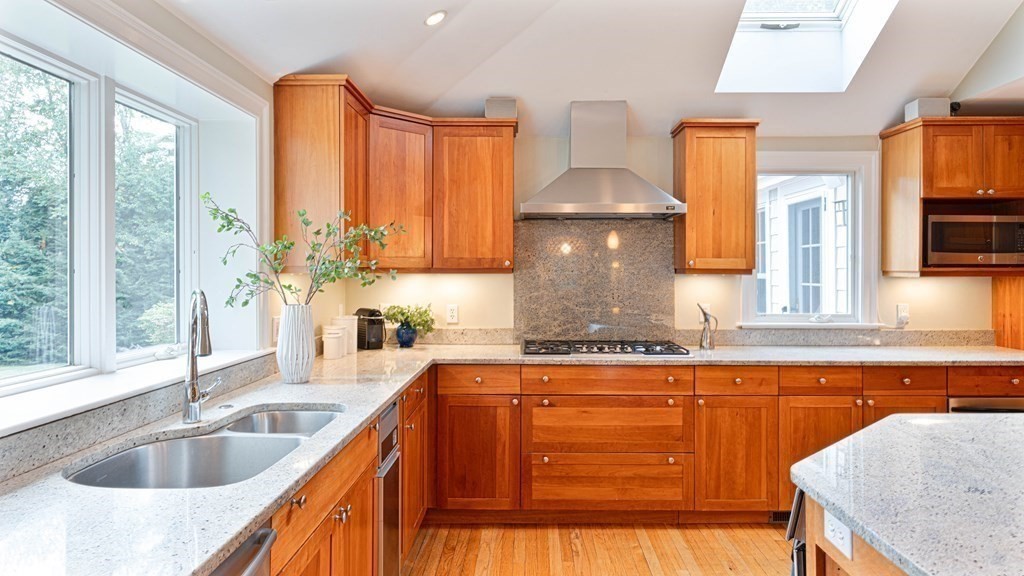 84 Wildwood Drive Needham, MA 02492 - Photo 6 of 36 a kitchen with granite countertop a sink a counter space and cabinets