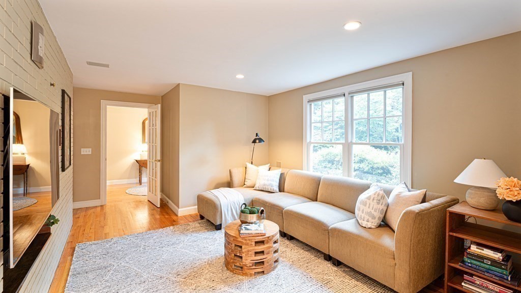 84 Wildwood Drive Needham, MA 02492 - Photo 9 of 36 a living room with furniture and a large window