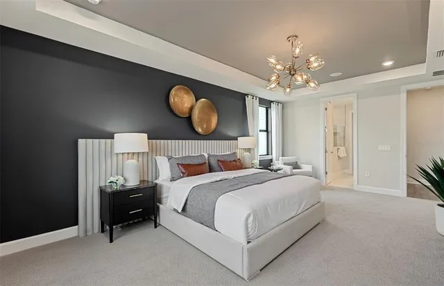 a bedroom with bed and a chandelier