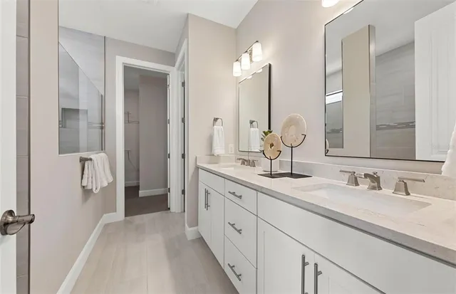 a bathroom with a double vanity sink mirror and double