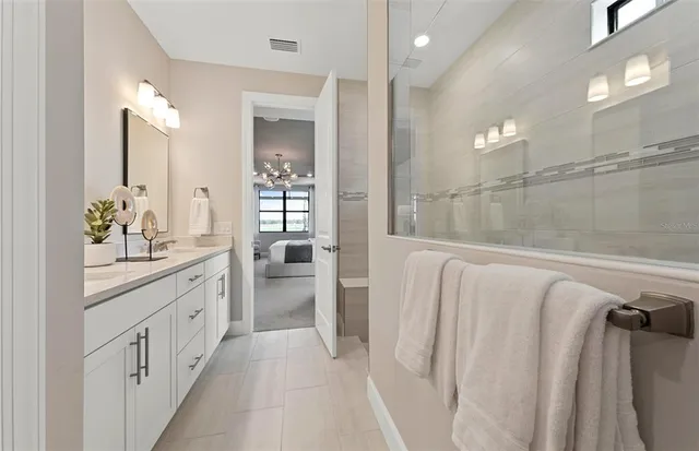 a bathroom with a double vanity sink and mirror