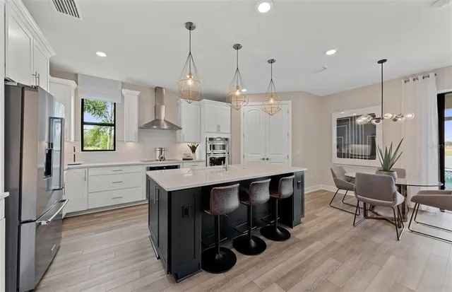 a kitchen with kitchen island a wooden floor and white appliances