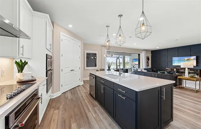 a large kitchen with stainless steel appliances a large center island and a stove