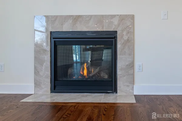 a living room with furniture a flat screen tv and a large window