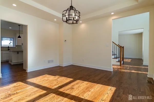 a view of a dining room with furniture wooden floor and chandelier