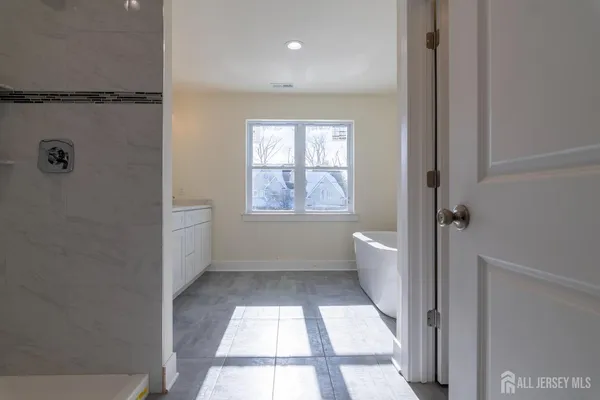 a bathroom with a shower and a bath tub