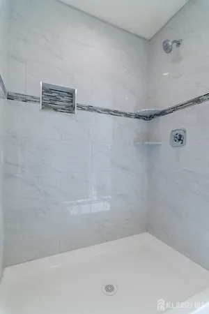 a bathroom with a bathtub sink and window