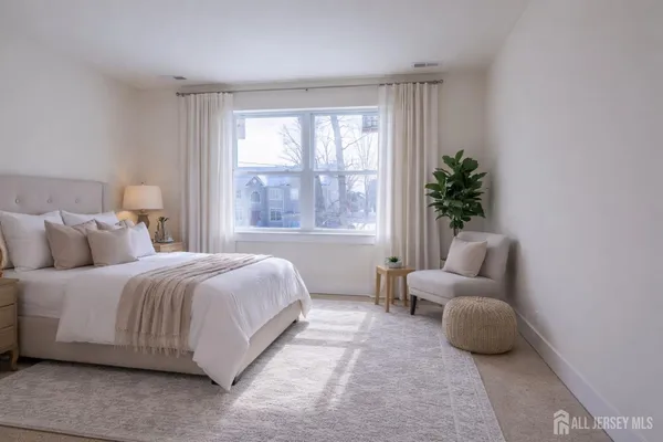a bathroom with a granite countertop shower a toilet and a window