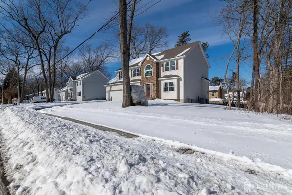 a view of a house with a snow on the road