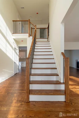 a view of entryway and hall with wooden floor