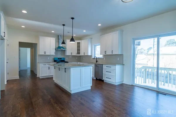 a kitchen with stainless steel appliances a sink stove and cabinets