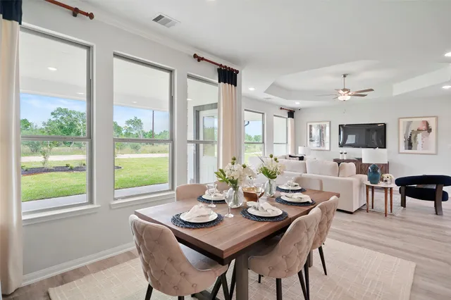 a living room with furniture and large windows
