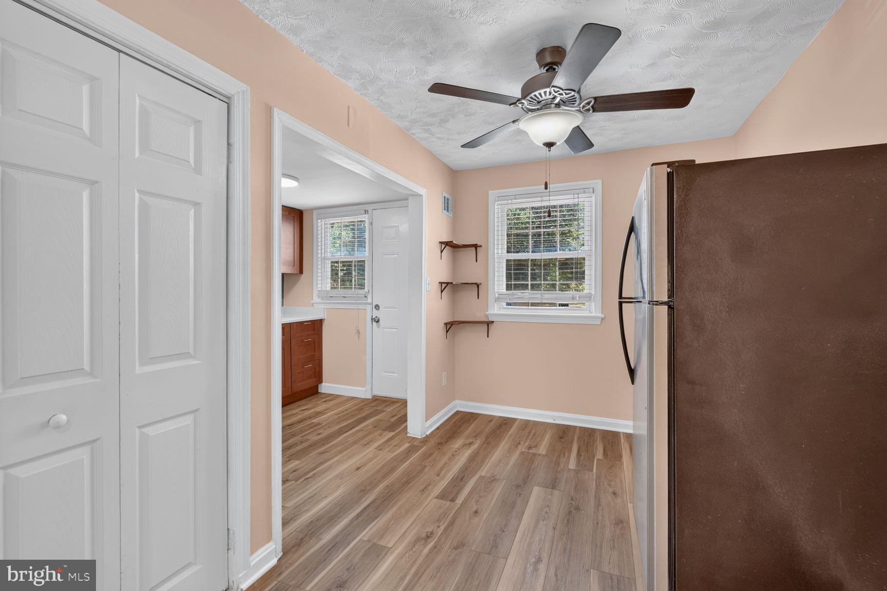 2437 Iverson Street Temple Hills, MD 20748 - Photo 5 of 15 a view of a livingroom with wooden floor and a ceiling fan