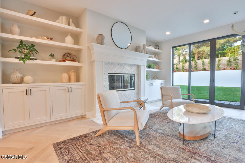 4630 Rio Bravo Court Moorpark, CA 93021 - Photo 12 of 58 a living room with furniture a rug and a fireplace