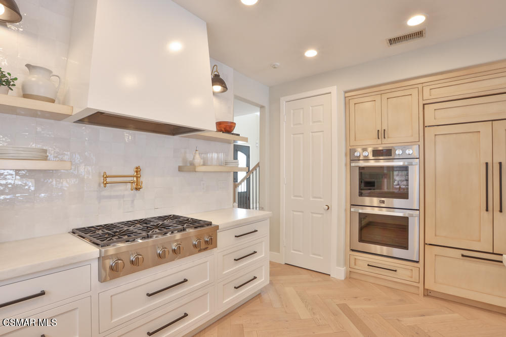 4630 Rio Bravo Court Moorpark, CA 93021 - Photo 25 of 58 a kitchen with stainless steel appliances granite countertop a stove and a refrigerator