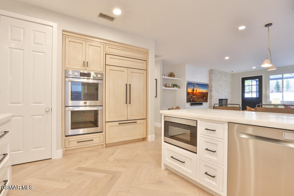 4630 Rio Bravo Court Moorpark, CA 93021 - Photo 28 of 58 a kitchen with white cabinets and white appliances